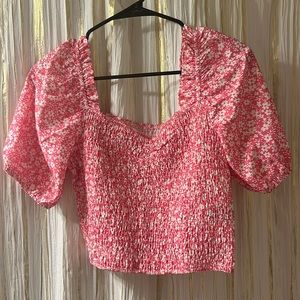 Cropped pink floral shirt has puffy sleeves